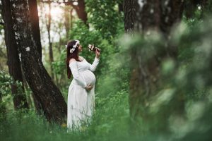 sunlight-flowers-beautiful-pregnant-woman-dress-have-walk-outdoors-positive-brunette